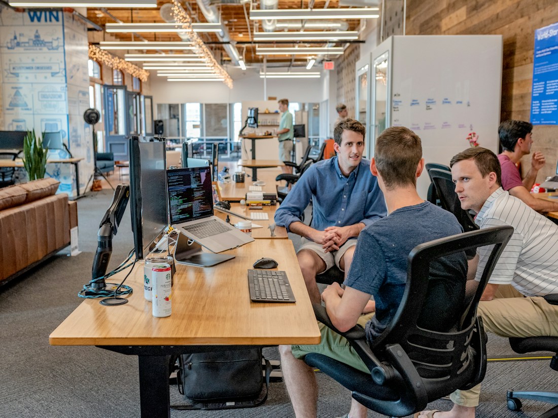 Technology team collaborating around a workspace